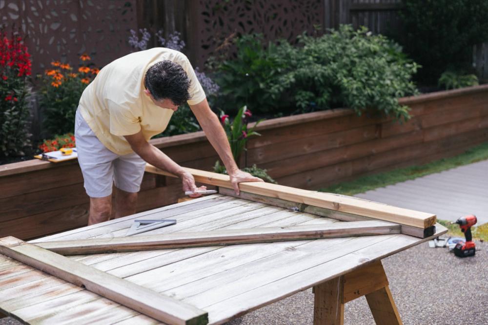 Laying a new board for the Z-frame over the old board and marking it with a pencil.