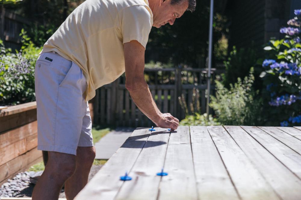 Placing ⅛” spacers between the fence boards.