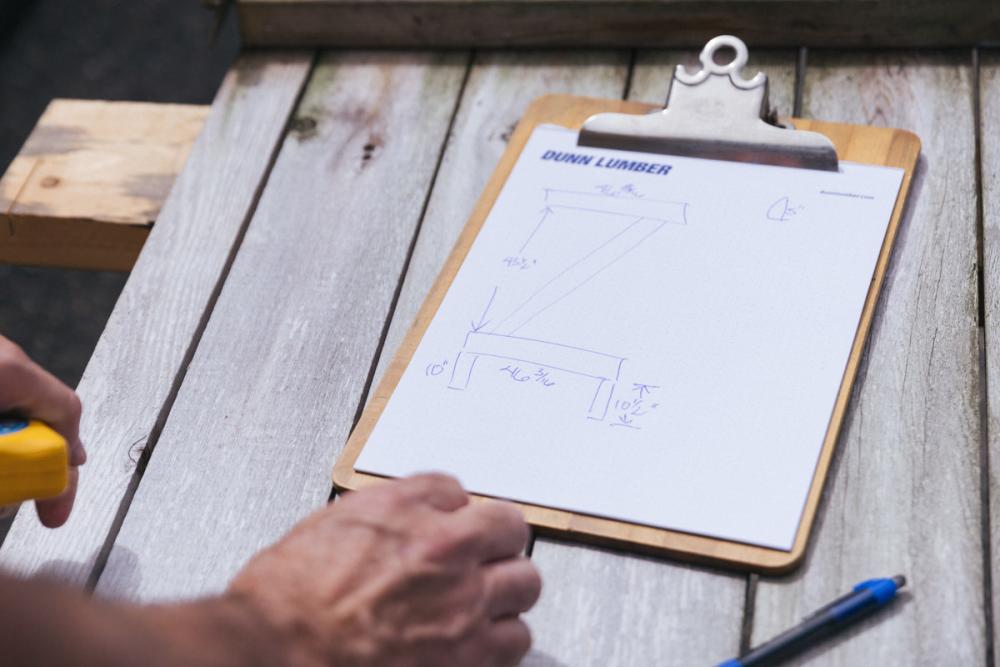 A clipboard with the measurements of the fence gate Z-frame taken down.