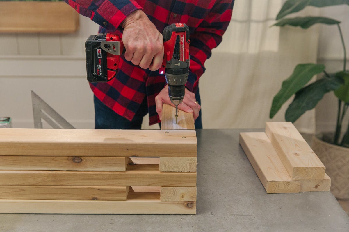 bench layers Driving screw to attach boards on top of each other at alternating right angles.