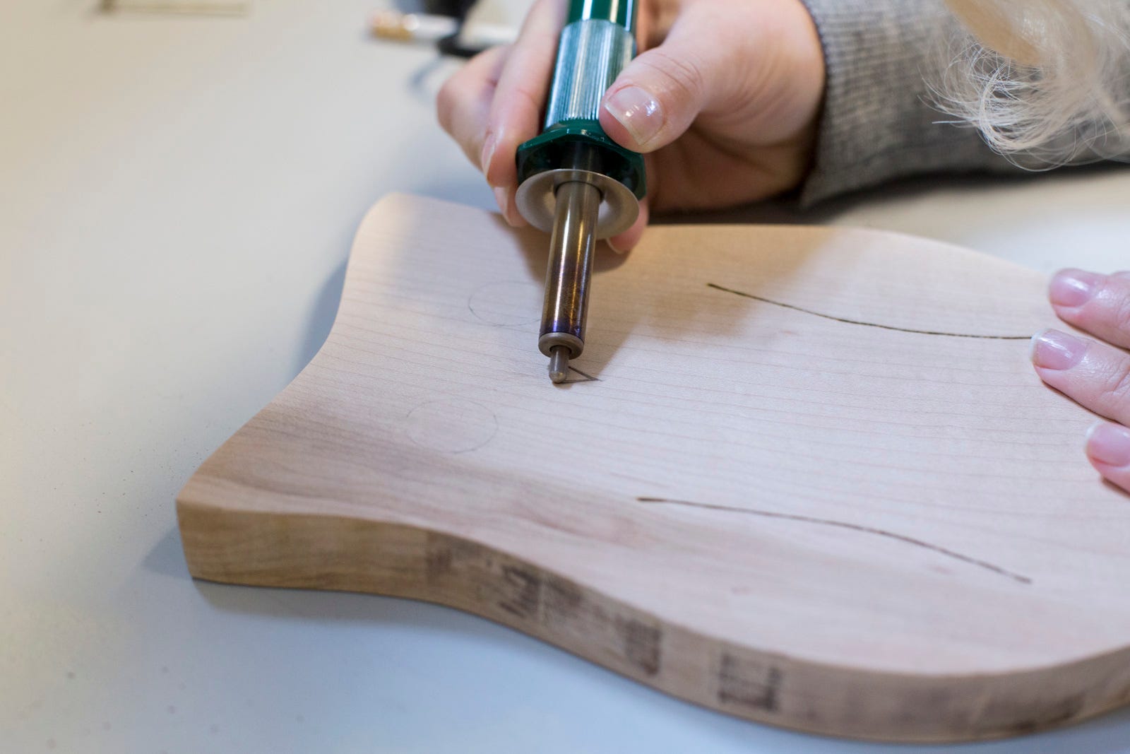 wood burner on cutting board