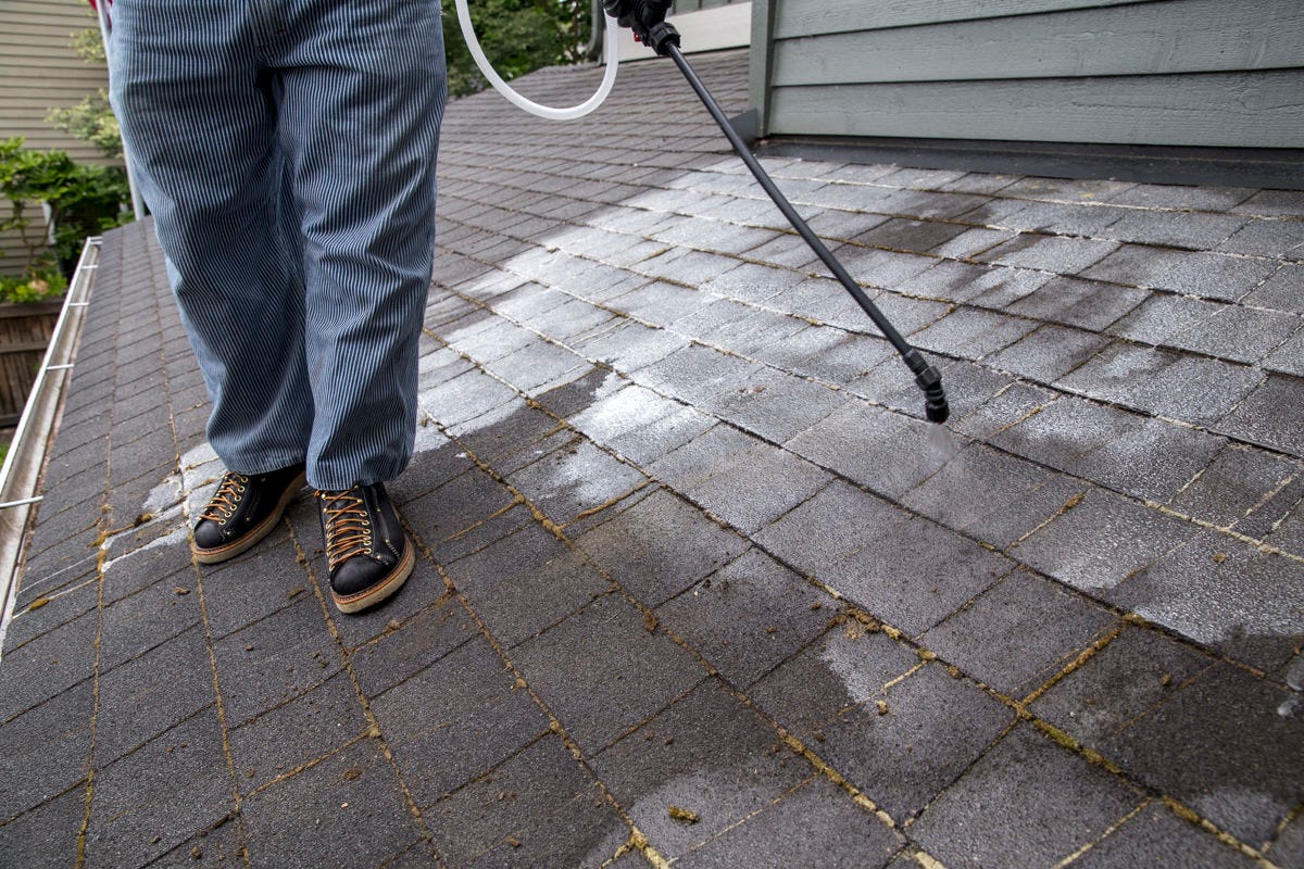 applying moss treatment to roof applying moss treatment to roof