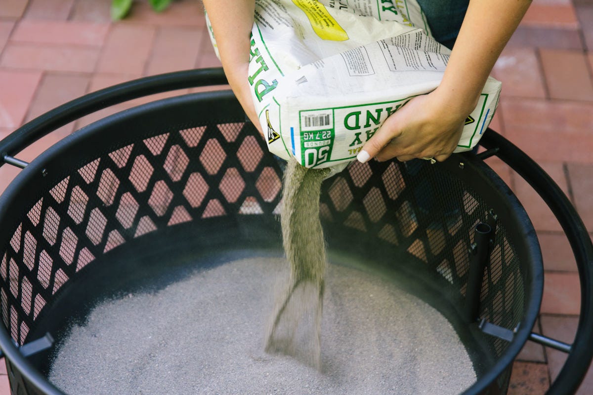add sand to fire pit Adding sand to fire pit.
