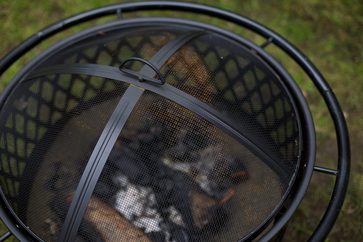 Outdoor fire pit with wood burning inside.