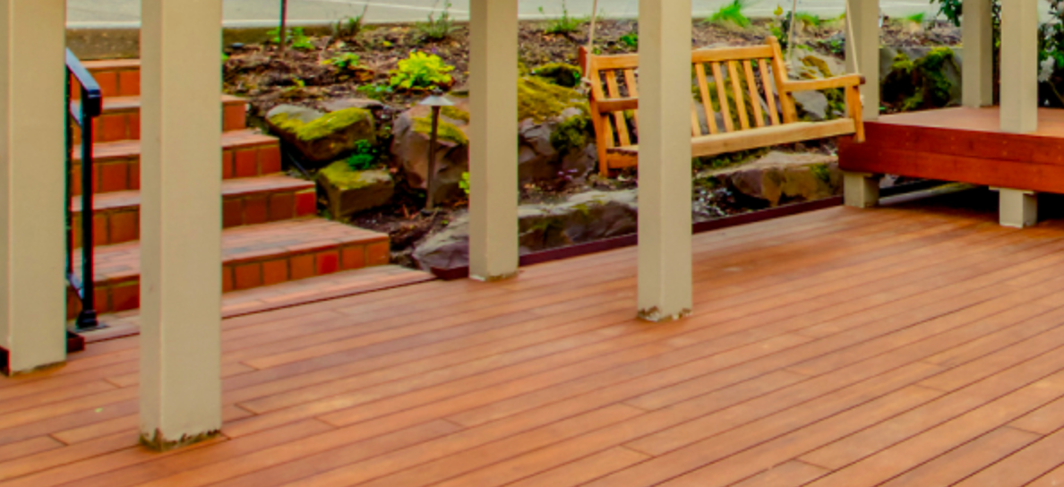 An outside covered deck with a swing above it.